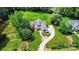 Expansive aerial view of a large house showcasing its well-maintained lawn and curved driveway at 9311 Simpson Rd, Waxhaw, NC 28173