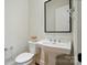 Half bath featuring modern vanity with marble countertop, chrome faucet, and tiled floor at 9311 Simpson Rd, Waxhaw, NC 28173