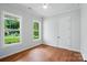 Bright bedroom featuring hardwood floors, ceiling fan and view to large yard at 9311 Simpson Rd, Waxhaw, NC 28173