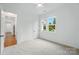 Bedroom featuring neutral carpet and a view to landscaped yard through large windows at 9311 Simpson Rd, Waxhaw, NC 28173
