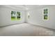 Spacious bedroom with plush carpeting and large windows, bringing in ample natural light at 9311 Simpson Rd, Waxhaw, NC 28173