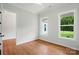 Bright bedroom featuring hardwood floors and an expansive view to the yard at 9311 Simpson Rd, Waxhaw, NC 28173
