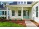 Inviting entrance showcasing double doors, white trim, and beautiful landscaping at 9311 Simpson Rd, Waxhaw, NC 28173
