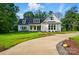 Charming home with a blue front door, a manicured lawn, and a winding concrete walkway at 9311 Simpson Rd, Waxhaw, NC 28173