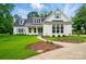Charming two-story home featuring a manicured lawn, a concrete walkway, and white siding accents at 9311 Simpson Rd, Waxhaw, NC 28173