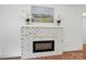 Cozy fireplace with painted brick surround, modern insert, and decorative mantle at 9311 Simpson Rd, Waxhaw, NC 28173