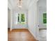The foyer boasts hardwood floors, a decorative light fixture, and views into adjoining rooms at 9311 Simpson Rd, Waxhaw, NC 28173