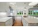 Gourmet kitchen featuring stainless steel appliances, marble counters, and a view of the breakfast nook at 9311 Simpson Rd, Waxhaw, NC 28173