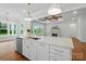 Open kitchen with large island, white cabinets, stainless appliances, and a view to the living room at 9311 Simpson Rd, Waxhaw, NC 28173