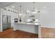 Elegant kitchen featuring a large center island, pendant lighting, and stainless steel appliances at 9311 Simpson Rd, Waxhaw, NC 28173
