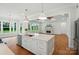 Bright open-concept kitchen island flows into living room and shows fireplace at 9311 Simpson Rd, Waxhaw, NC 28173