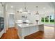 Bright kitchen island with white marble countertops, pendant lights, and stainless appliances at 9311 Simpson Rd, Waxhaw, NC 28173