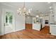 Open floor plan showcasing kitchen with island, stainless appliances, and view to the dining room at 9311 Simpson Rd, Waxhaw, NC 28173