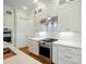 Well-lit kitchen features stainless steel stove and range hood, marble countertops and white cabinets at 9311 Simpson Rd, Waxhaw, NC 28173