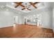 Bright open-concept living room with hardwood floors, coffered ceiling, and adjacent kitchen at 9311 Simpson Rd, Waxhaw, NC 28173