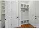 Bright mudroom with ample storage, built-in shelving, coat hooks and hardwood floor at 9311 Simpson Rd, Waxhaw, NC 28173