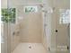 Modern shower with marble walls, glass door, showerhead and a window that brings in natural light at 9311 Simpson Rd, Waxhaw, NC 28173
