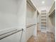 Bright walk-in closet offers ample storage with built-in shelving and metal hanging rods at 9311 Simpson Rd, Waxhaw, NC 28173