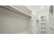 Bright walk-in closet with window offers ample storage with built-in shelving and metal hanging rods at 9311 Simpson Rd, Waxhaw, NC 28173