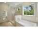 Bright bathroom featuring a soaking tub, glass-enclosed shower, and natural light at 9315 Simpson Rd, Waxhaw, NC 28173