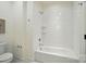 A clean, bright bathroom with white tile surround, a soaking tub and modern fixtures at 9315 Simpson Rd, Waxhaw, NC 28173