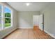 Bright bedroom features hardwood floors, a ceiling fan, and a large window with a picturesque view at 9315 Simpson Rd, Waxhaw, NC 28173