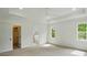 Large bedroom with carpet, tray ceiling, and two windows at 9315 Simpson Rd, Waxhaw, NC 28173