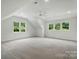 A bonus room with a vaulted ceiling, carpet, lots of space, and multiple windows at 9315 Simpson Rd, Waxhaw, NC 28173