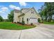 A charming exterior view showcasing a light-colored two-story home with an attached two car garage at 9315 Simpson Rd, Waxhaw, NC 28173