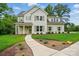 Charming two-story home with manicured lawn, beautiful landscaping, and inviting walkway at 9315 Simpson Rd, Waxhaw, NC 28173