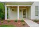 Inviting front porch featuring wooden ceiling, brick accents, and well-maintained landscaping at 9315 Simpson Rd, Waxhaw, NC 28173