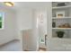 Bright hallway with built-in shelving and a view of the stairway with an elegant chandelier at 9315 Simpson Rd, Waxhaw, NC 28173