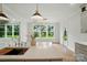 Kitchen island with faucet, stainless dishwasher, and dining area with natural light from the windows at 9315 Simpson Rd, Waxhaw, NC 28173
