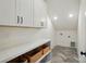 The laundry room has white cabinets, a counter, and gray tile flooring at 9315 Simpson Rd, Waxhaw, NC 28173