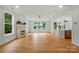 Cozy living room with a fireplace, large windows, and hardwood floors at 9315 Simpson Rd, Waxhaw, NC 28173