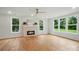 Spacious living room with hardwood floors, brick fireplace, and lots of natural light at 9315 Simpson Rd, Waxhaw, NC 28173