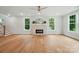 Open living room with hardwood floors, a fireplace, and a staircase at 9315 Simpson Rd, Waxhaw, NC 28173