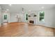 Bright living room with hardwood floors, brick fireplace, and large windows at 9315 Simpson Rd, Waxhaw, NC 28173