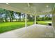 An inviting covered patio with ceiling fans offers a relaxing outdoor space overlooking a lush yard at 9315 Simpson Rd, Waxhaw, NC 28173