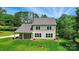 Back view of the home showcasing its well-manicured lawn and covered patio at 9315 Simpson Rd, Waxhaw, NC 28173