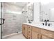 Modern bathroom featuring dual sinks, a glass-enclosed shower, and stylish fixtures at 1011 Sandy Ct, Gastonia, NC 28056