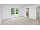 Bright bedroom featuring carpet, neutral walls, and large windows providing natural light at 1011 Sandy Ct, Gastonia, NC 28056
