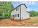 Exterior angle of a two-story white house with a small deck and black trim at 1011 Sandy Ct, Gastonia, NC 28056