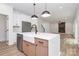 Gourmet kitchen featuring stainless appliances, kitchen island with seating, and access to the main living room at 1011 Sandy Ct, Gastonia, NC 28056