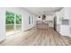 Bright open concept kitchen with stainless appliances, an island, and access to an outdoor deck at 1011 Sandy Ct, Gastonia, NC 28056