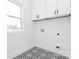 Bright laundry room with unique tile flooring and a window providing natural light at 1011 Sandy Ct, Gastonia, NC 28056