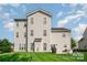 Rear view of home with gray siding, nice lawn, patio, and plenty of windows at 10515 Greenhead View Rd, Charlotte, NC 28262