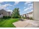 Backyard with a patio, green lawn, grill, storage shed, and privacy fence at 10515 Greenhead View Rd, Charlotte, NC 28262