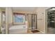 Bathroom featuring a glass-enclosed shower and a separate soaking tub at 10515 Greenhead View Rd, Charlotte, NC 28262