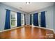 Bright bedroom with hardwood floors and natural light from the large windows at 10515 Greenhead View Rd, Charlotte, NC 28262